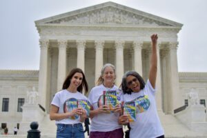 Annie Finch, Desiree Cooper, and Ashley Jordan in front of the Supreme Court with copies of Choice Words